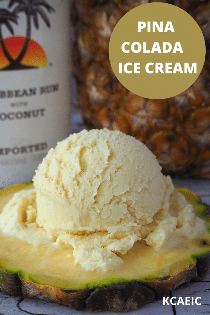 scoop of pina colada ice cream on pineapple slice, with coconut rum and pineapple in background, and text overlay, pina colada ice cream and KCAEIC.