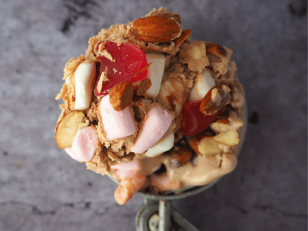 Scoop of rocky road ice cream on ice cream scoop.