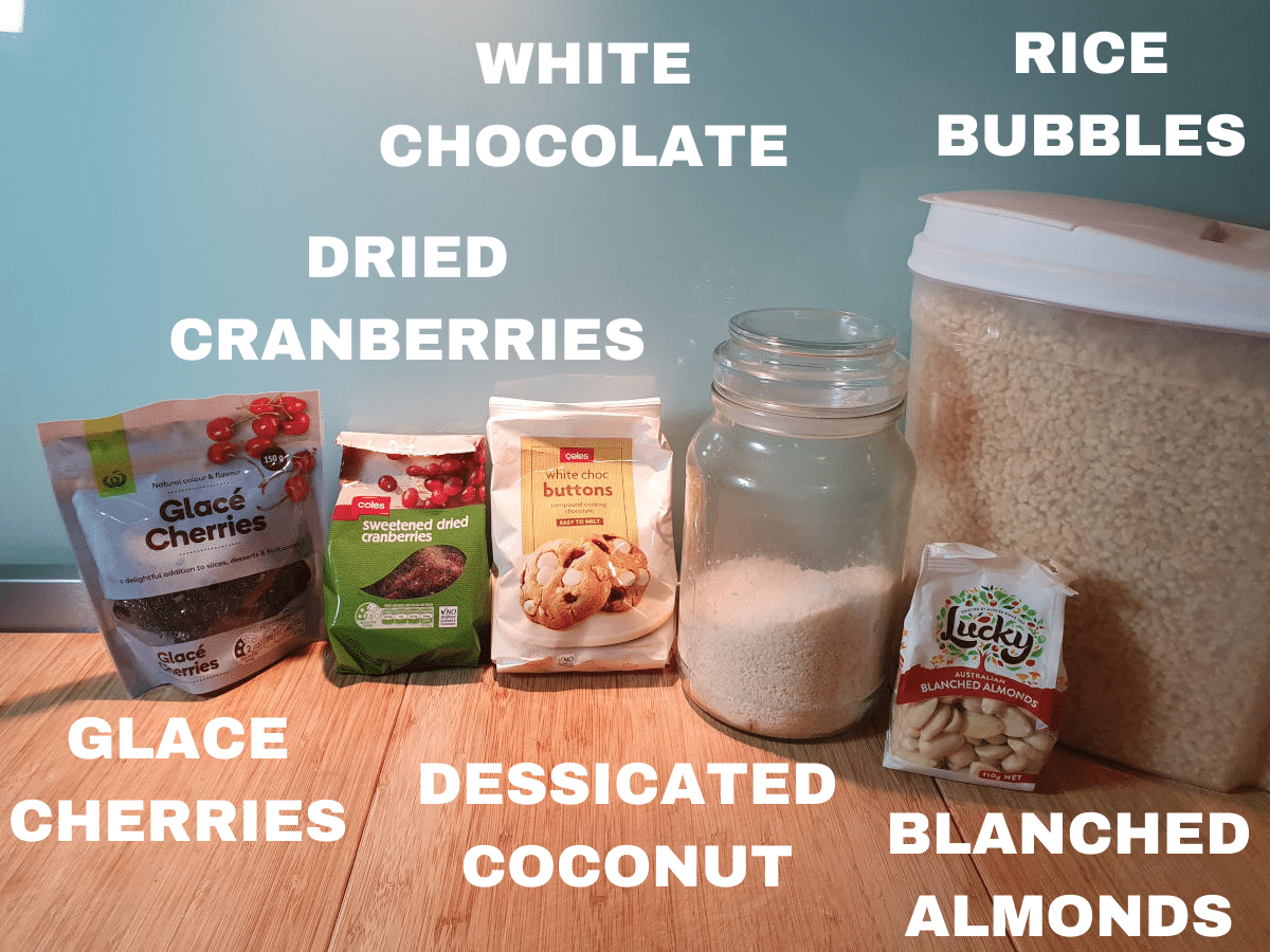 White Christmas ingredients, glace cherries, dried cranberried, white chocolate melts, dessicated coconut, blanched almonds, rice bubbles.