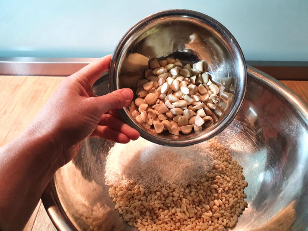 adding chopped blanched almonds to mix in bowl.