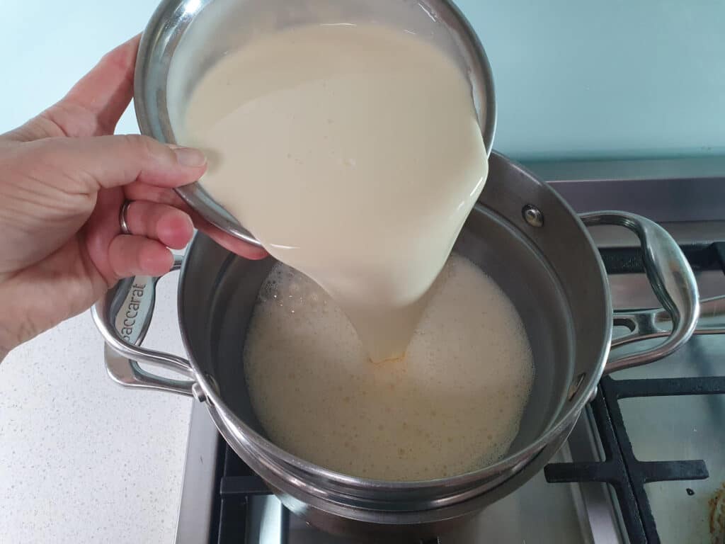 adding cream to ice cream mix in double boiler.