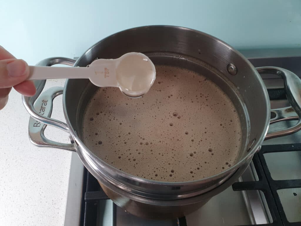 adding optional glucose syrup to ice cream mix in double boiler.