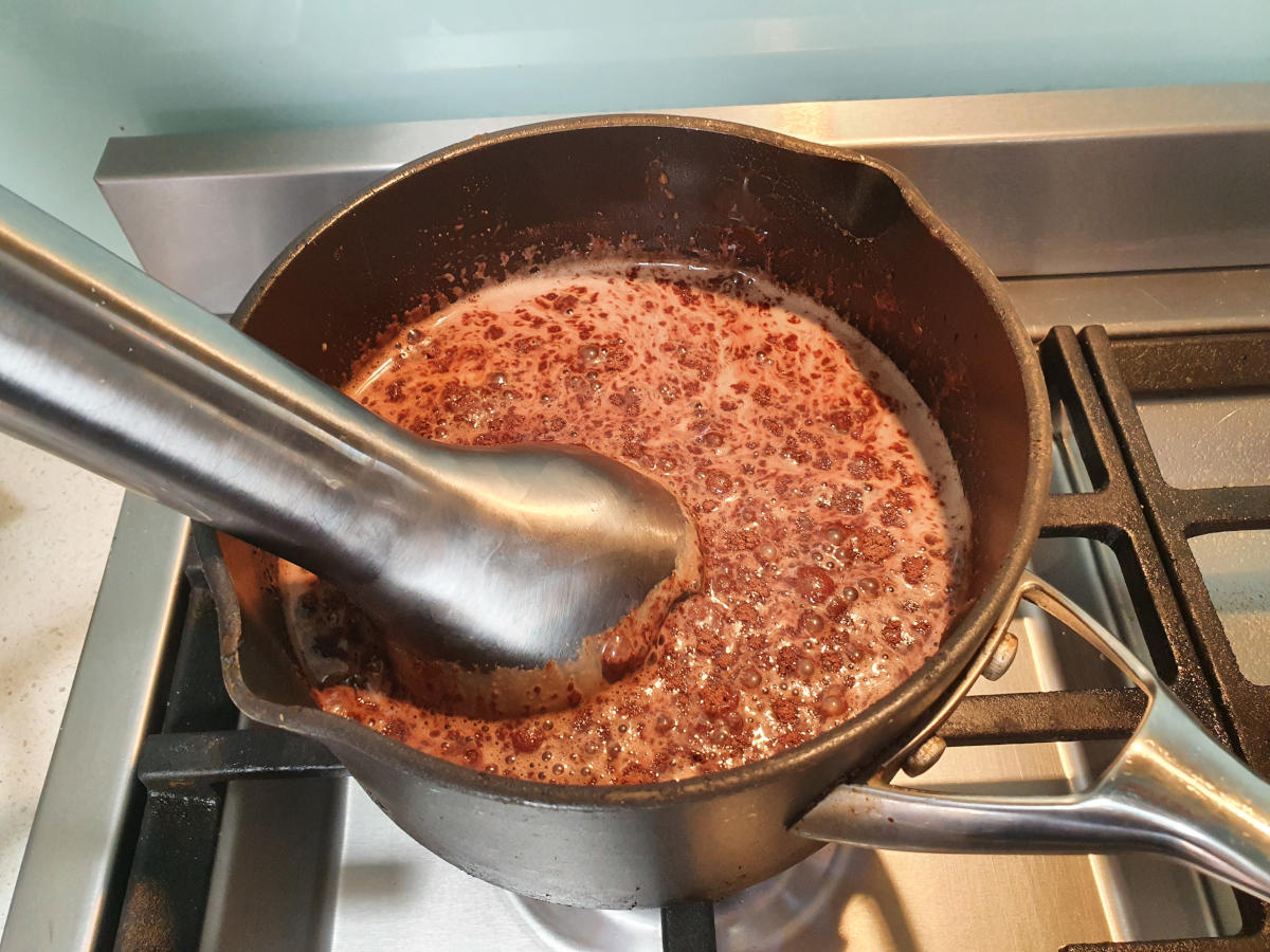 blending ice cream mix with an immersion blender.