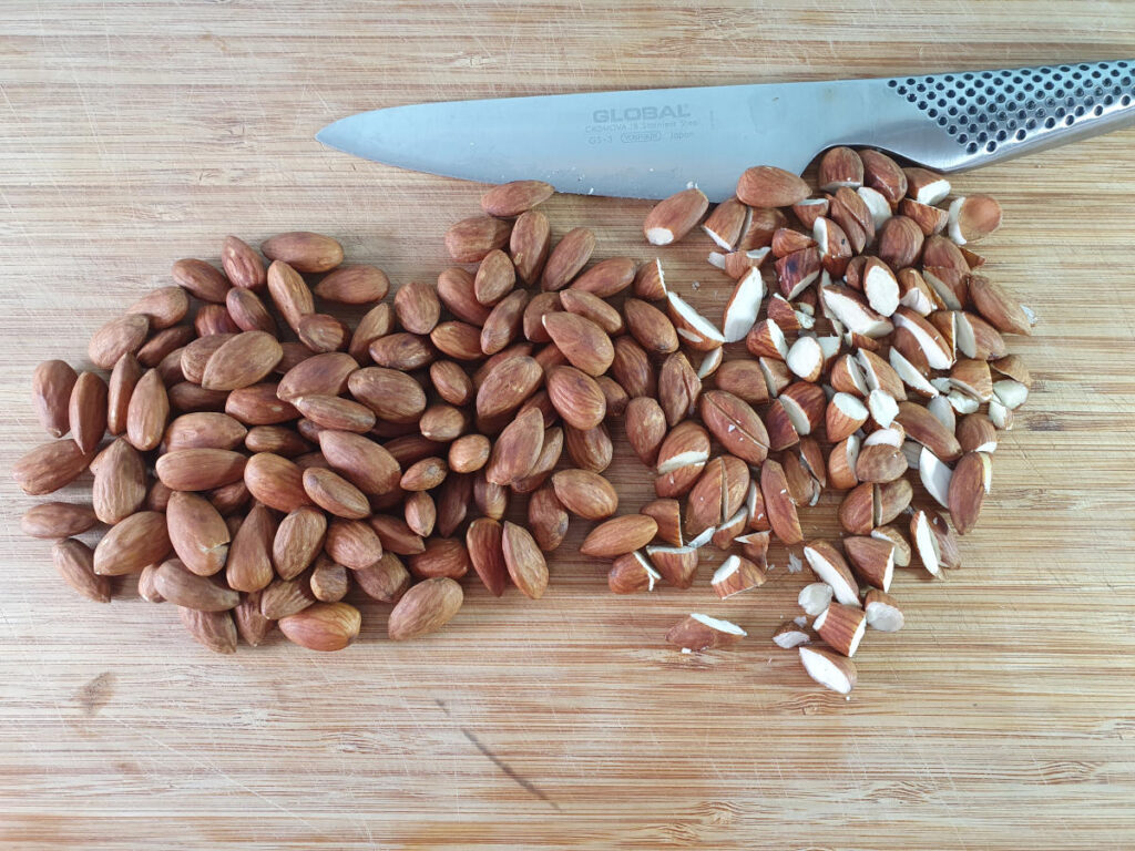 chopping up cooled roasted almonds.