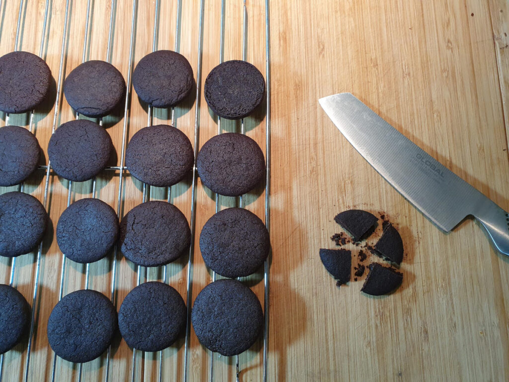 chopping up homemade Oreos into quarters.