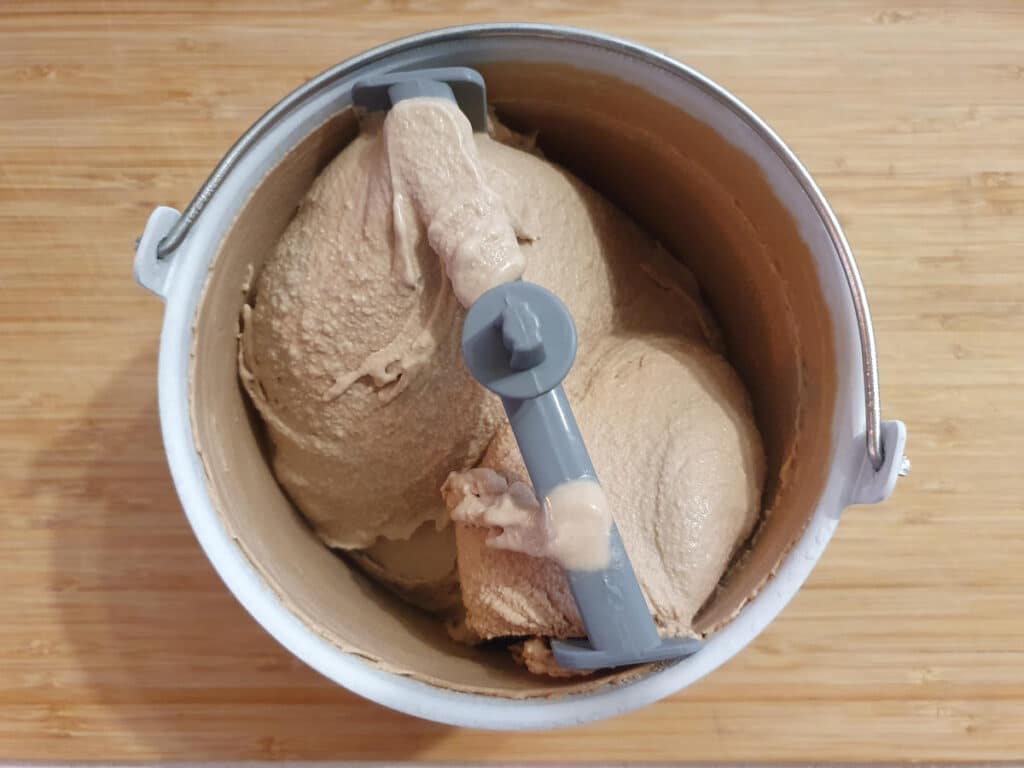 top down view of churned milk chocolate ice cream in churning bowl.
