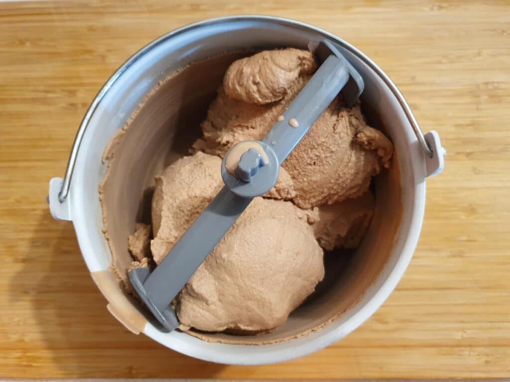 top down view of churned milo ice cream in churning bowl.