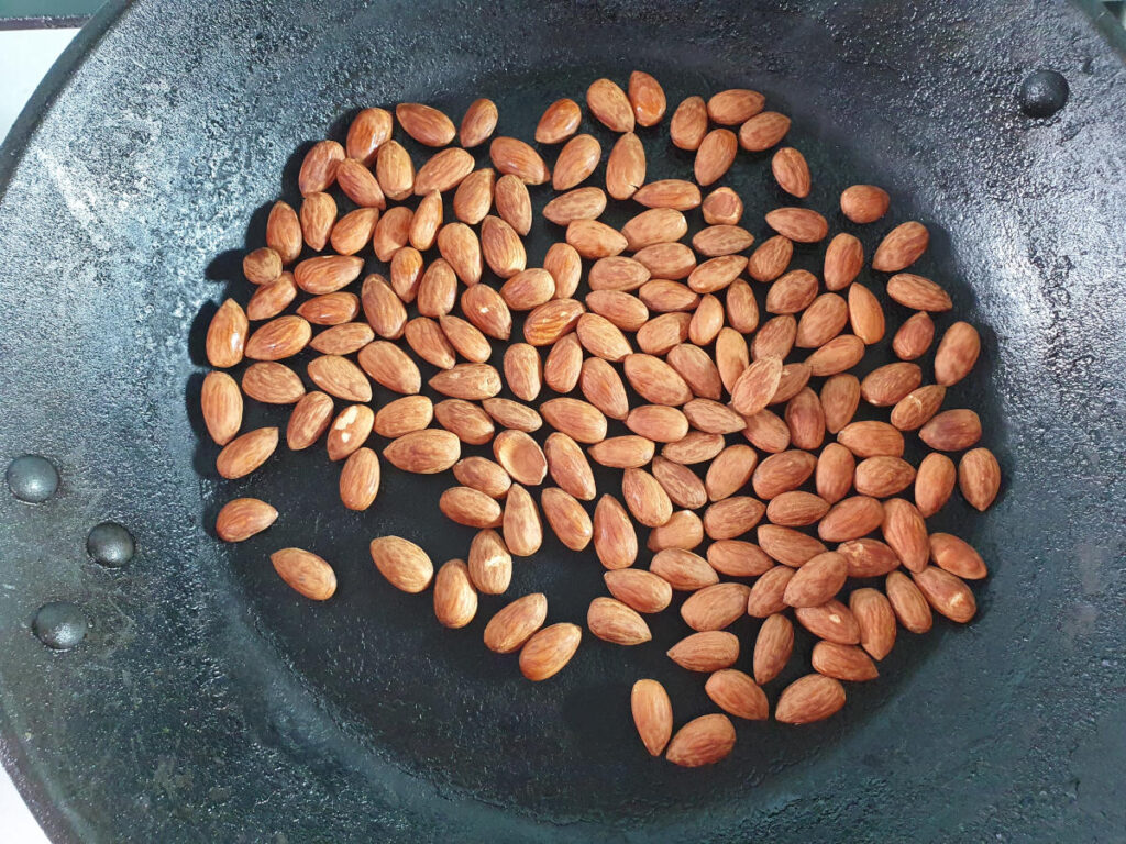 dry roasting almonds in a frying pan.