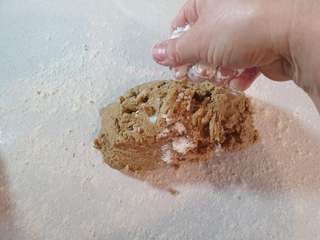 sprinkling dough with flour to prevent sticking when rolling out.