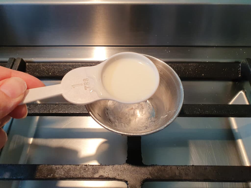 adding milk to small bowl with tapioca starch in it to make a slurry.