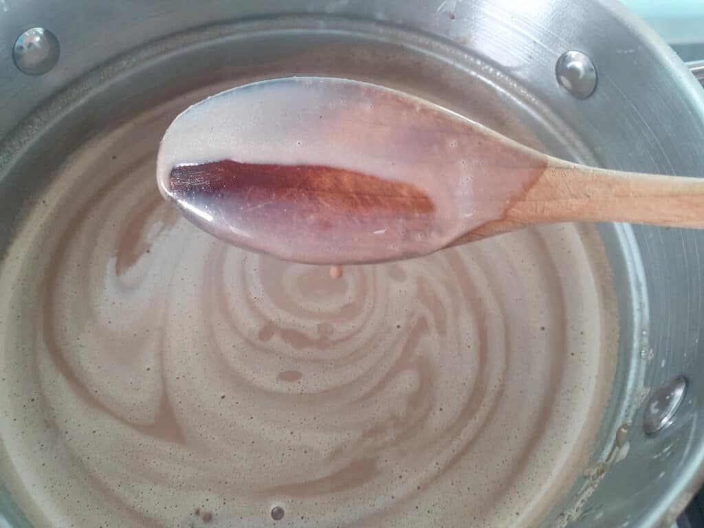 mix coating back of wooden spoon and leaving a line when you run your finger through it.