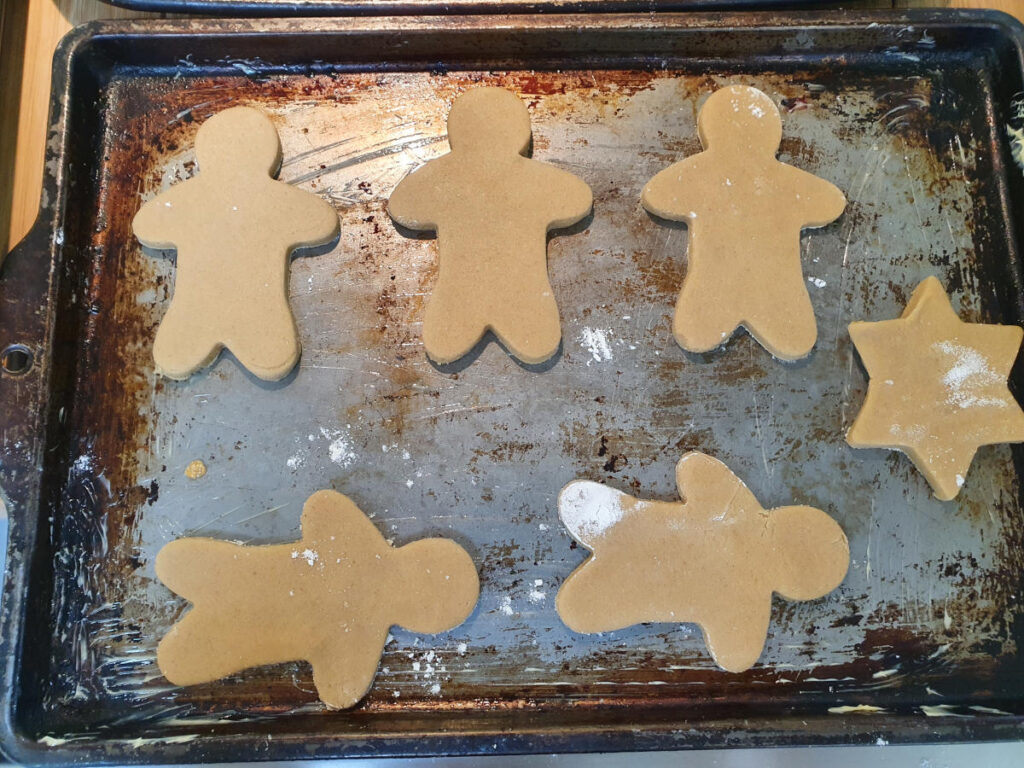 Gingerbread men 17 ready to bake cookies on a baking tray.