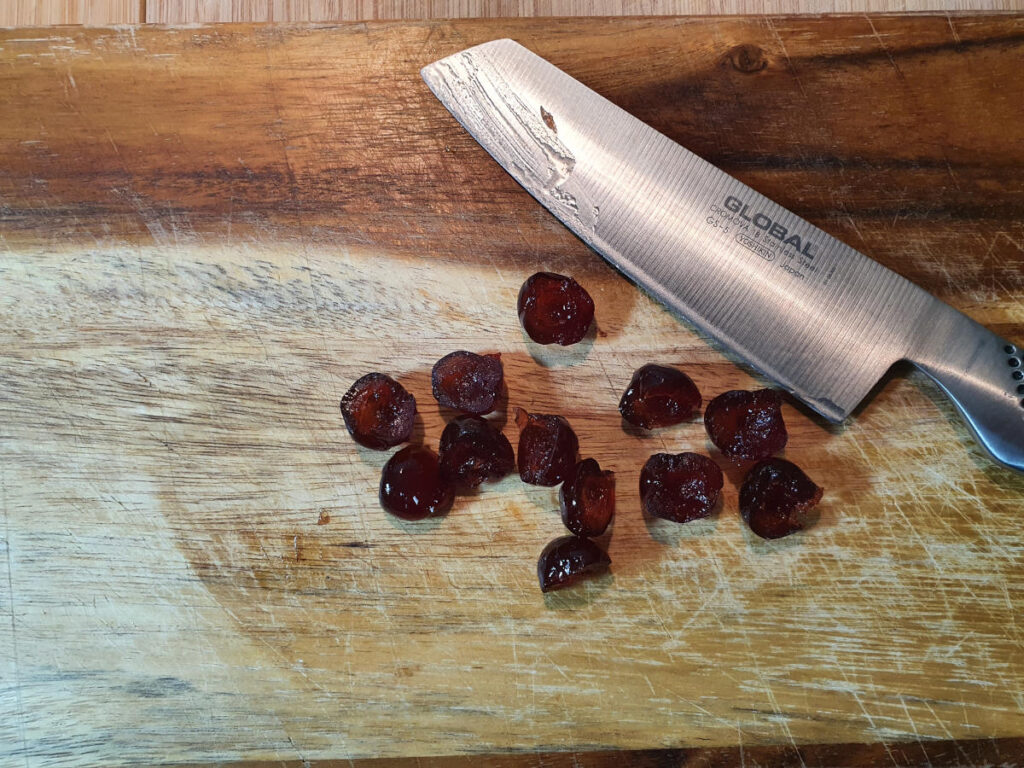 slicing cherries with a sharp knife.