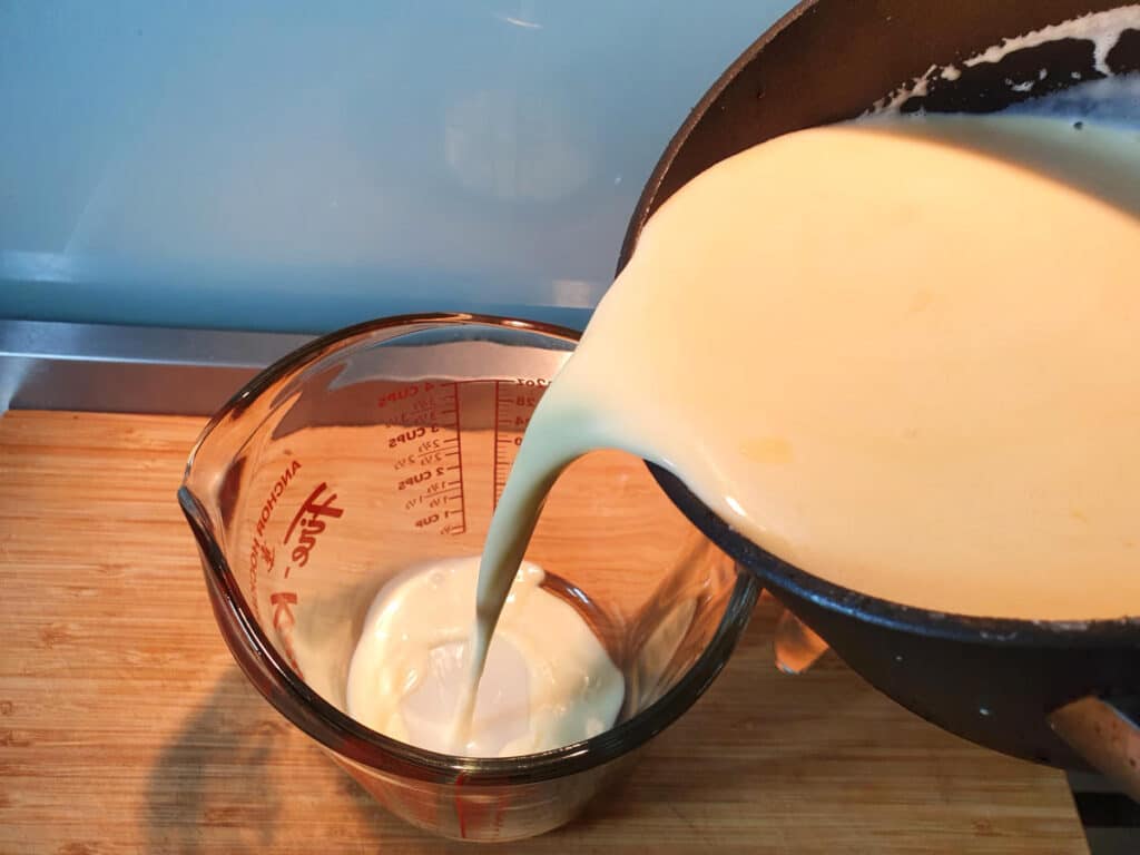 Transferring ice cream mix to heat proof jug to chill in fridge.