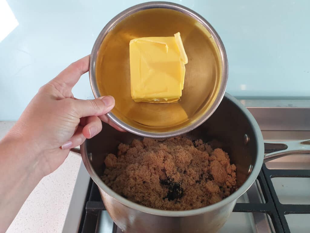 adding butter to pot on stove.