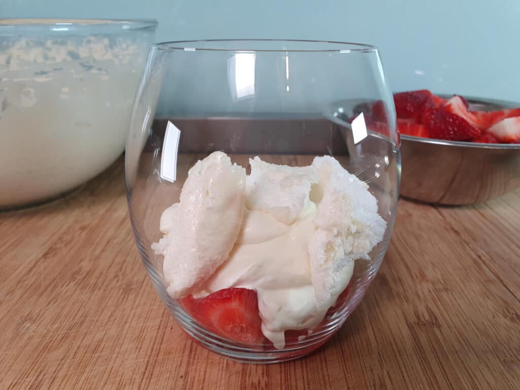 Eton mess 21 adding first layer cream mix and broken up meringues.