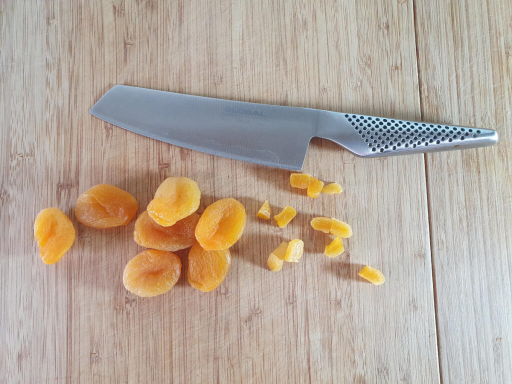 chopping apricots into small pieces.