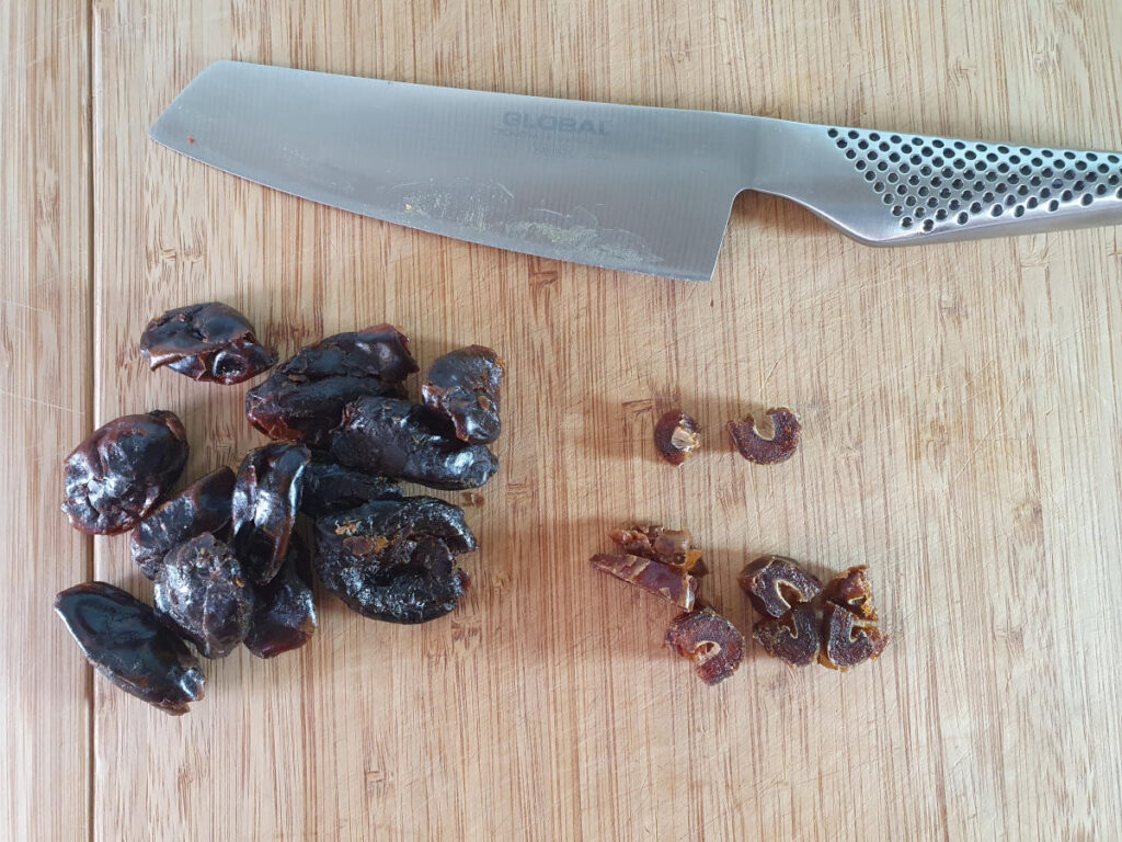 chopping pitted dates into small pieces.