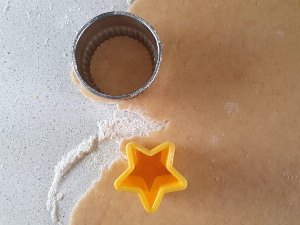 cutting out bases and start tops from dough.