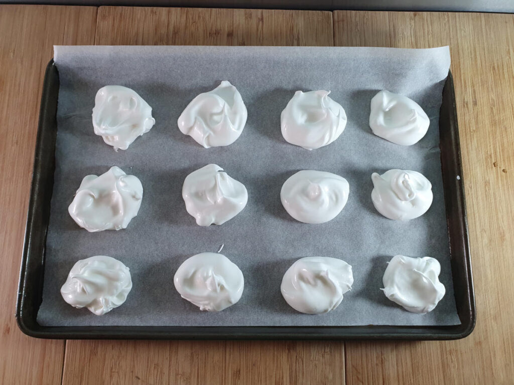 Eton mess 9 meringues on tray ready to bake.