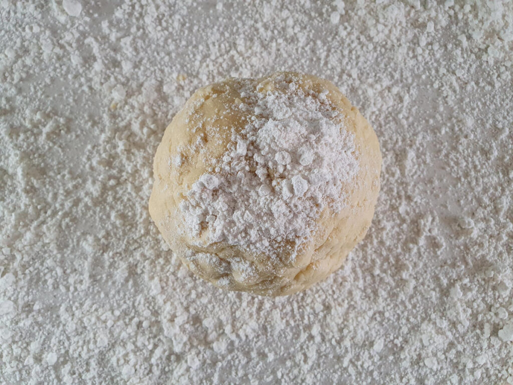 Gluten free shortbread 11 read to roll dough on floured surface, with flour dusting on top.
