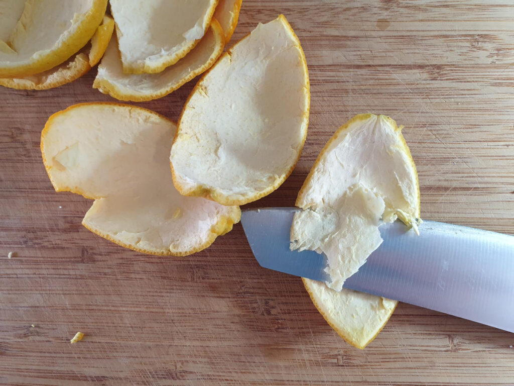 removing some of the white pith from the orange peel by skimming carefully with a sharp knif.