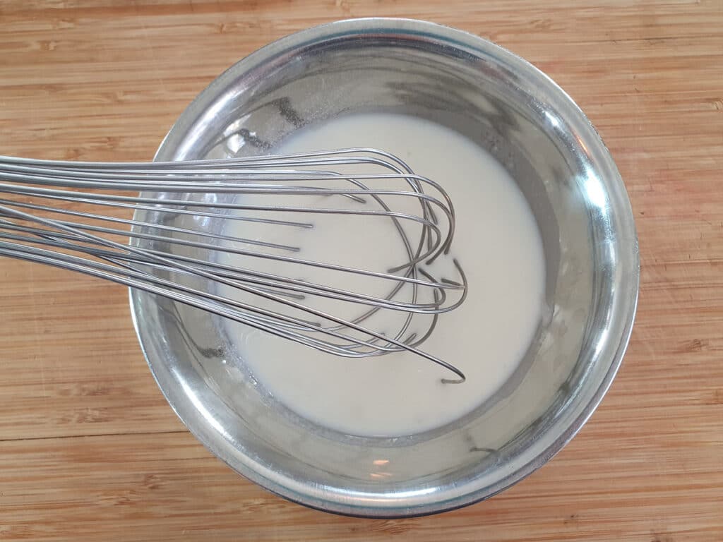 Whisking bloomed gelatin into milk