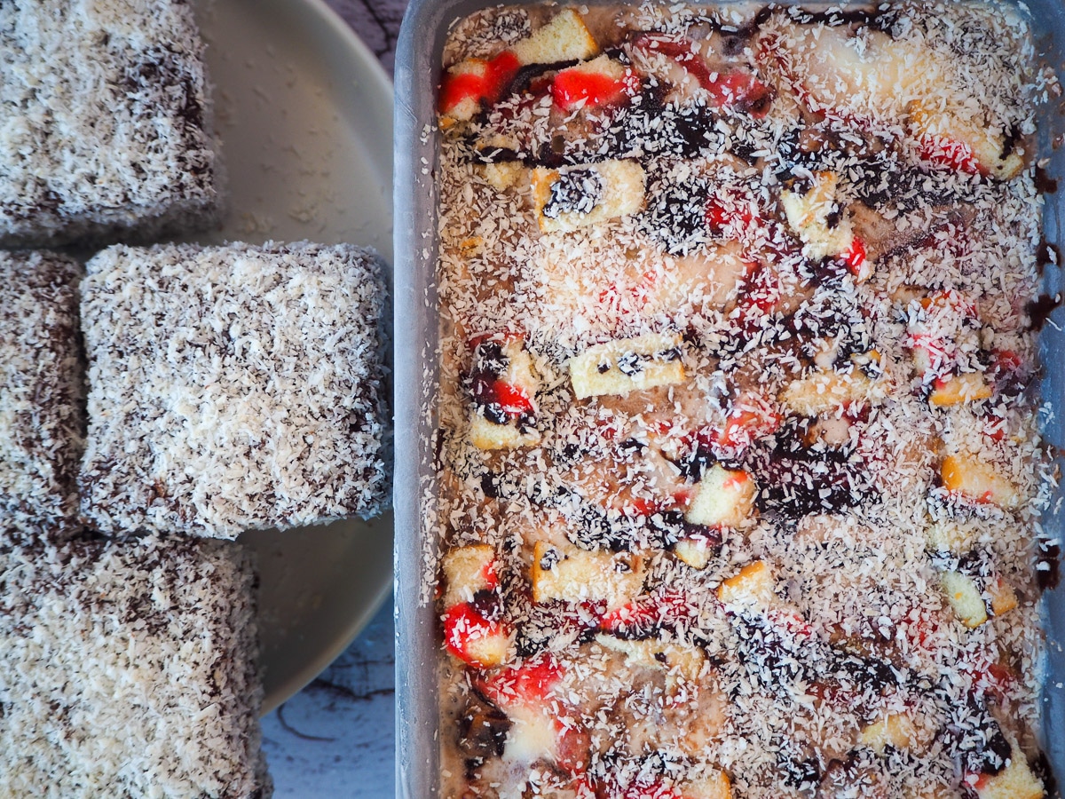 Top down view of lamington ice cream in pan with lamingtons on the side.