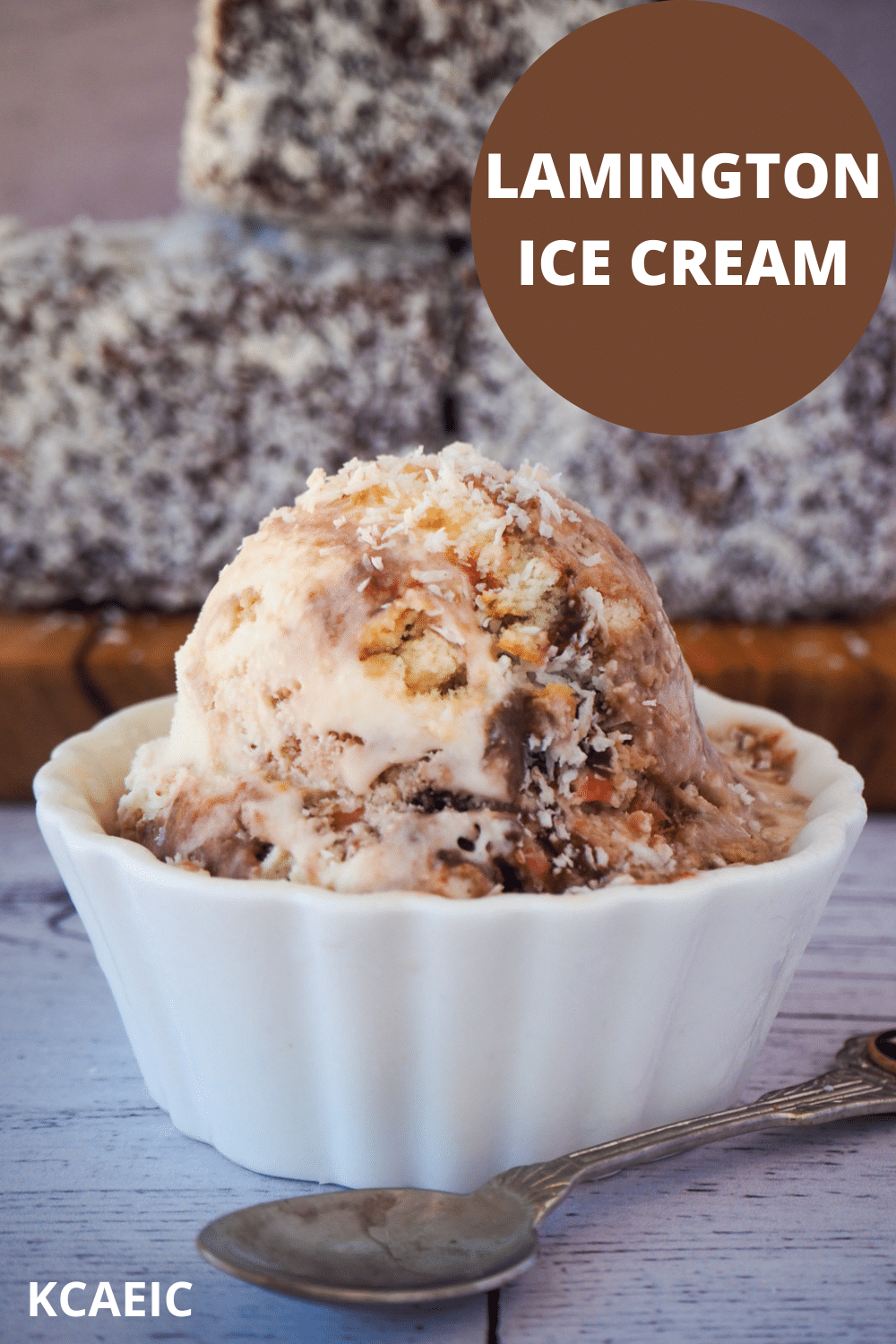 Scoop of lamington ice cream with vintage spoon on the side, in front of stacked lamingtons on a board, with text overlay, Lamington ice cream, KCAEIC