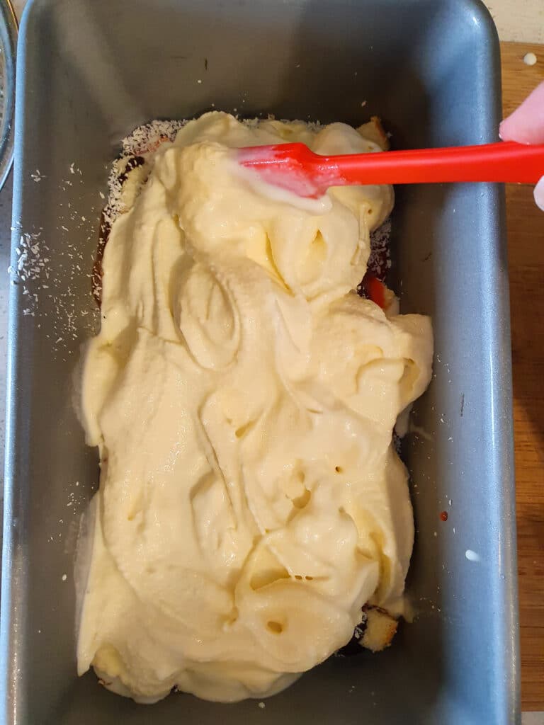 Swirling first layer of ice cream and mix ins. with a small spatula.