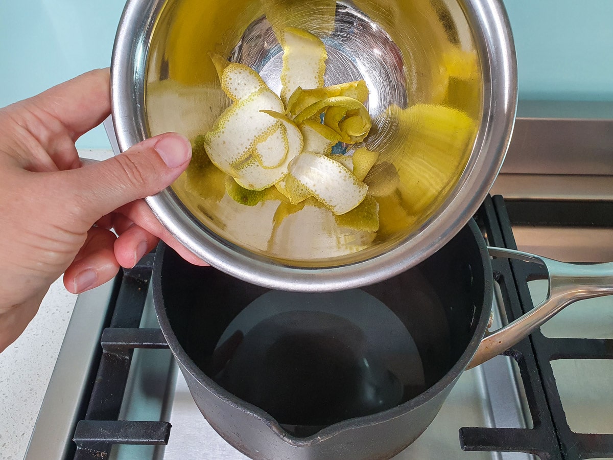 Adding lime zest to pot.