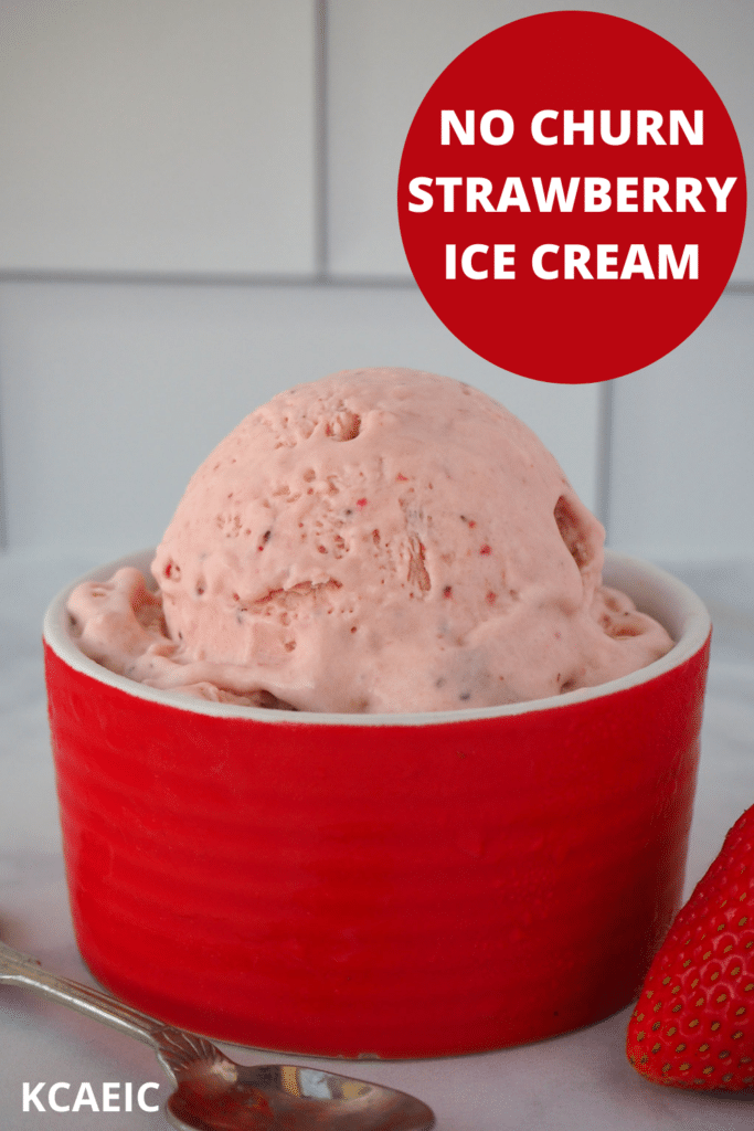 Scoop of no churn strawberry ice cream in a red bowl, with a spoon and fresh strawberry on the side and text overlay, No churn strawberry ice cream and KCAEIC