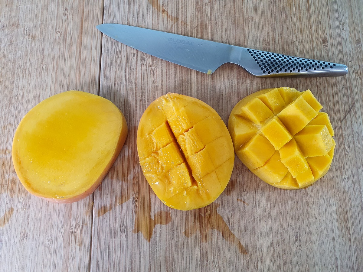 Slicing mango flesh into cubes before slicing off.