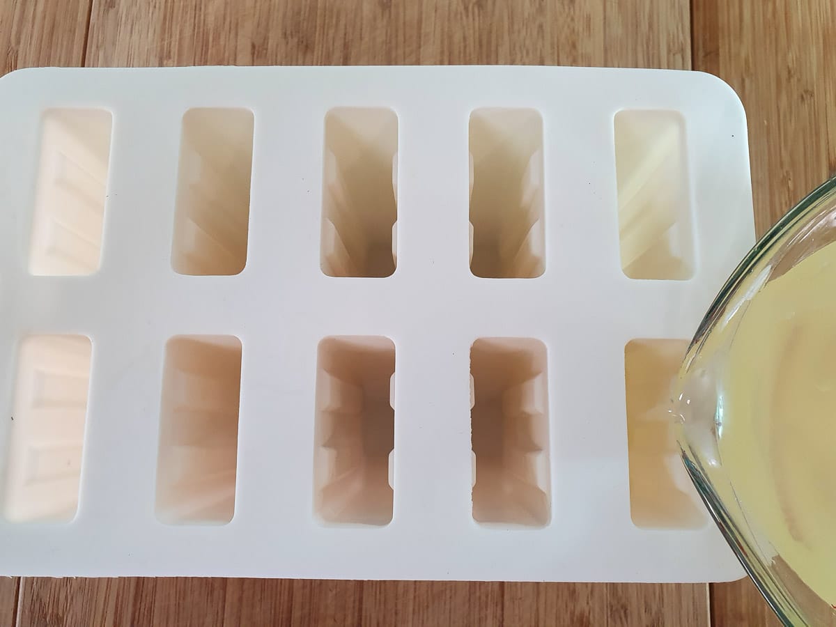 Lemonade popsicles 13 Pouring popsicle mix into popsicle molds.