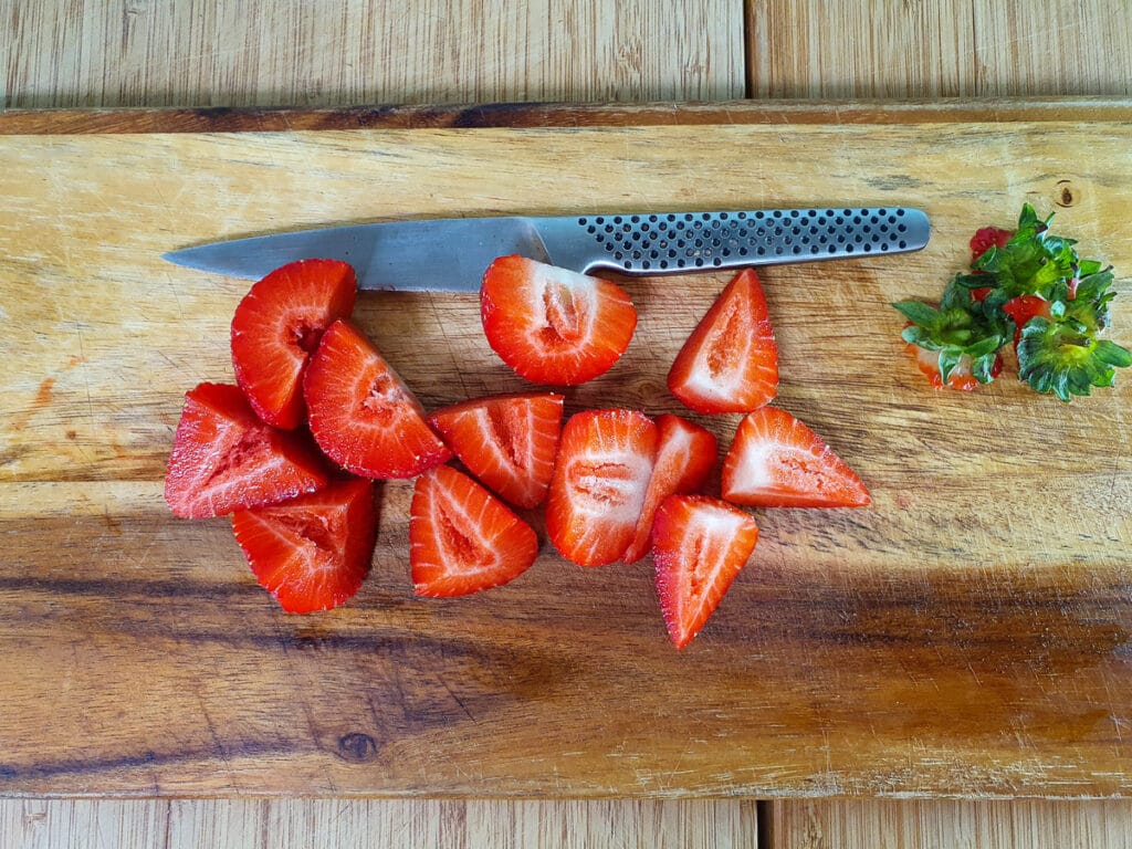 Mini strawberry cheesecake 8 Chopping up strawberries.