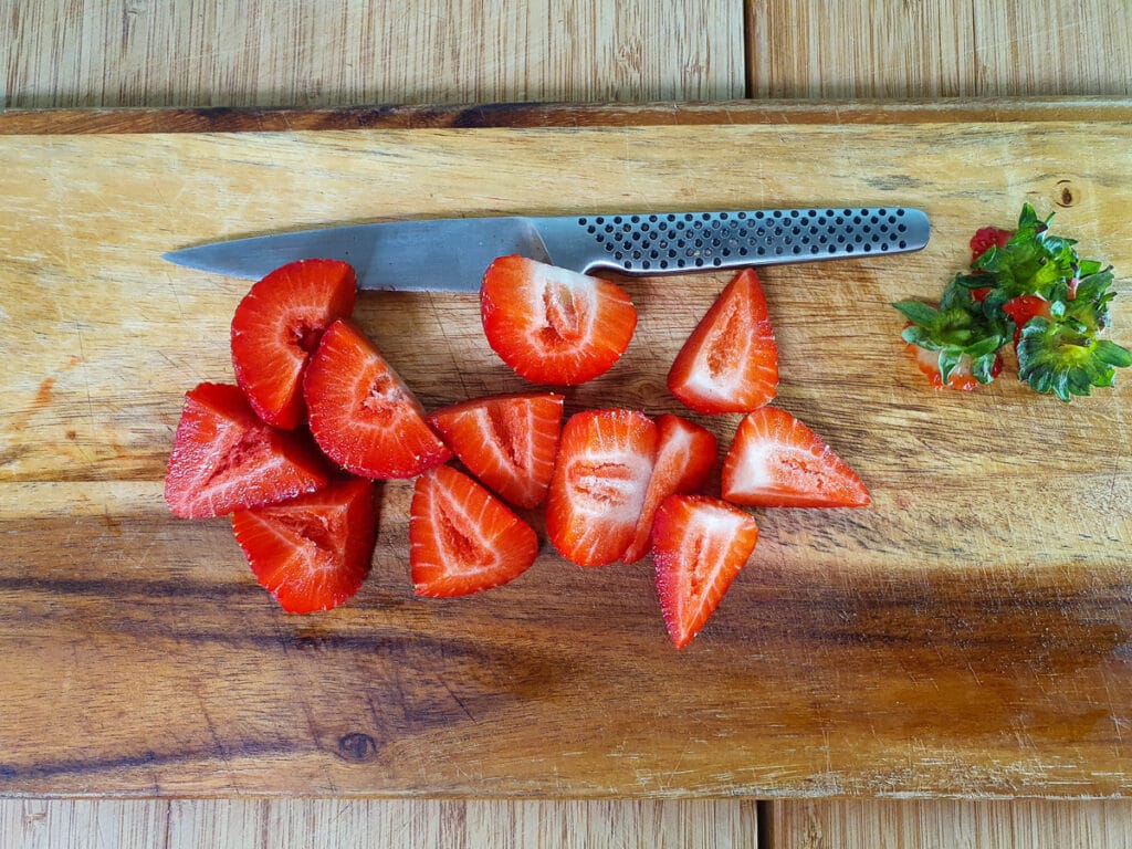 Chopping up strawberries.