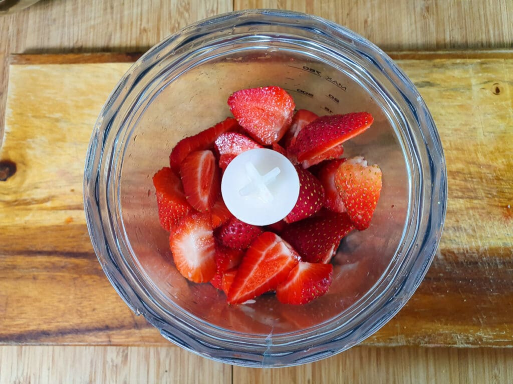 Strawberries in chopping bowl to blitz.
