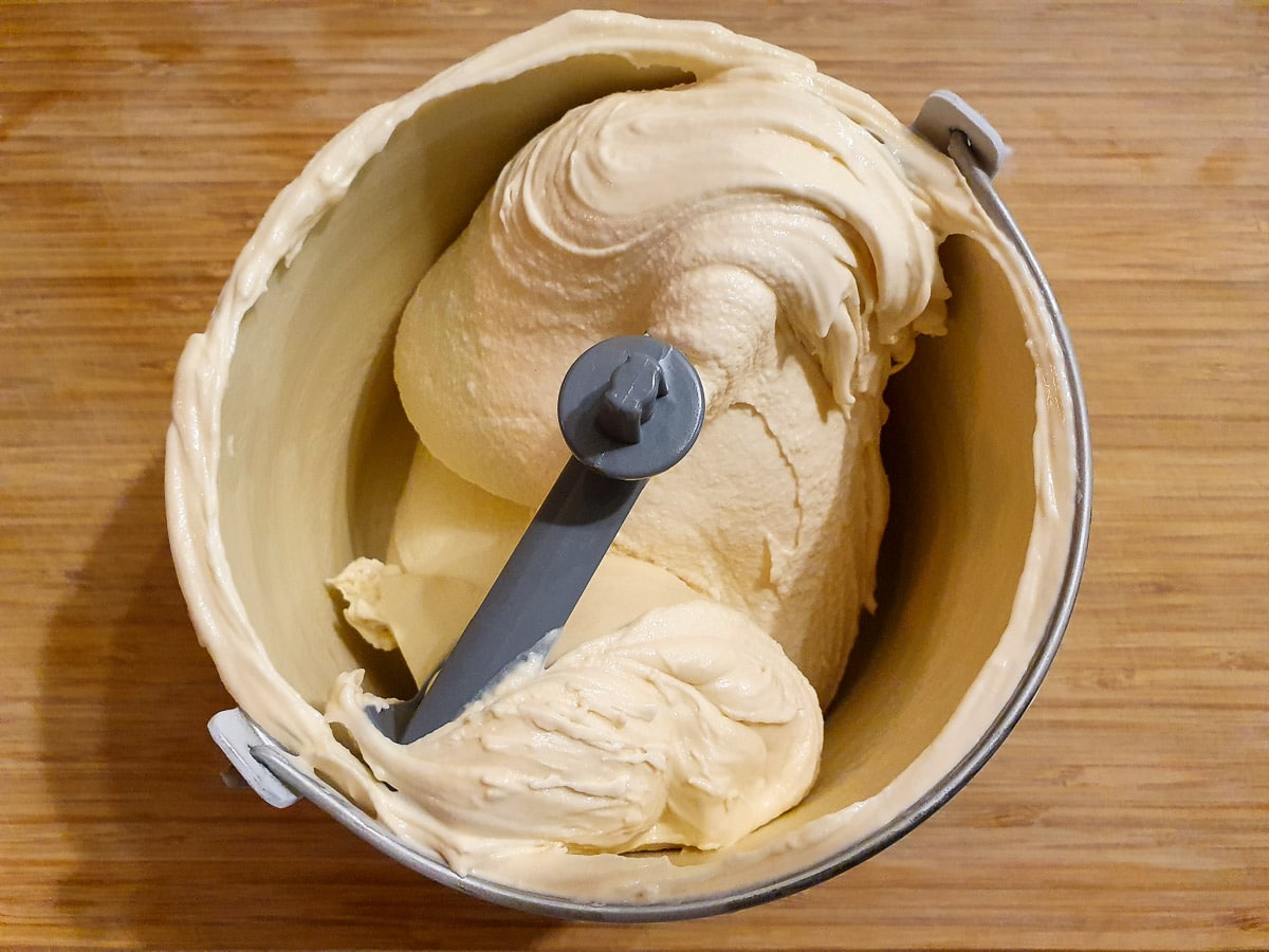 churned ice cream in churning bowl on a chopping board.