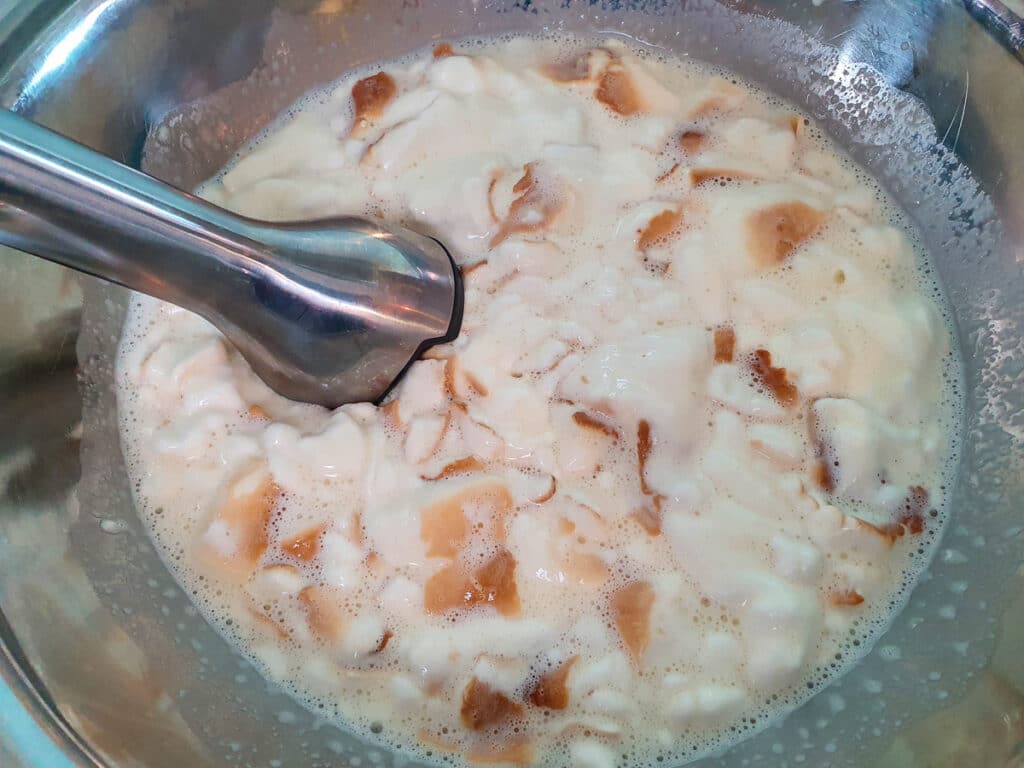 Blending ice cream mix with an immersion blender.