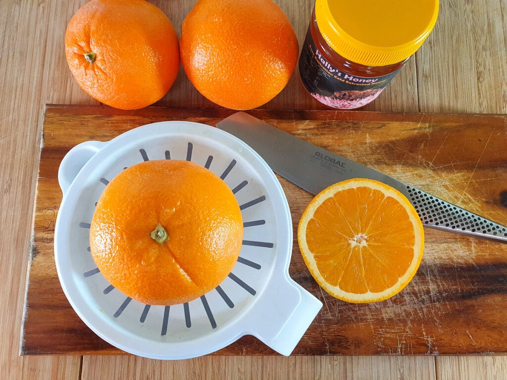 Juicing oranges with a juicer.