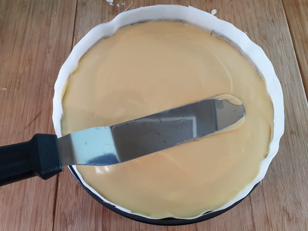 Passion fruit cheesecake 18 Smoothing down top of cheesecake with a spatula