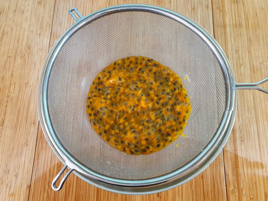 Passion fruit cheesecake 10 Straining passion fruit pulp,