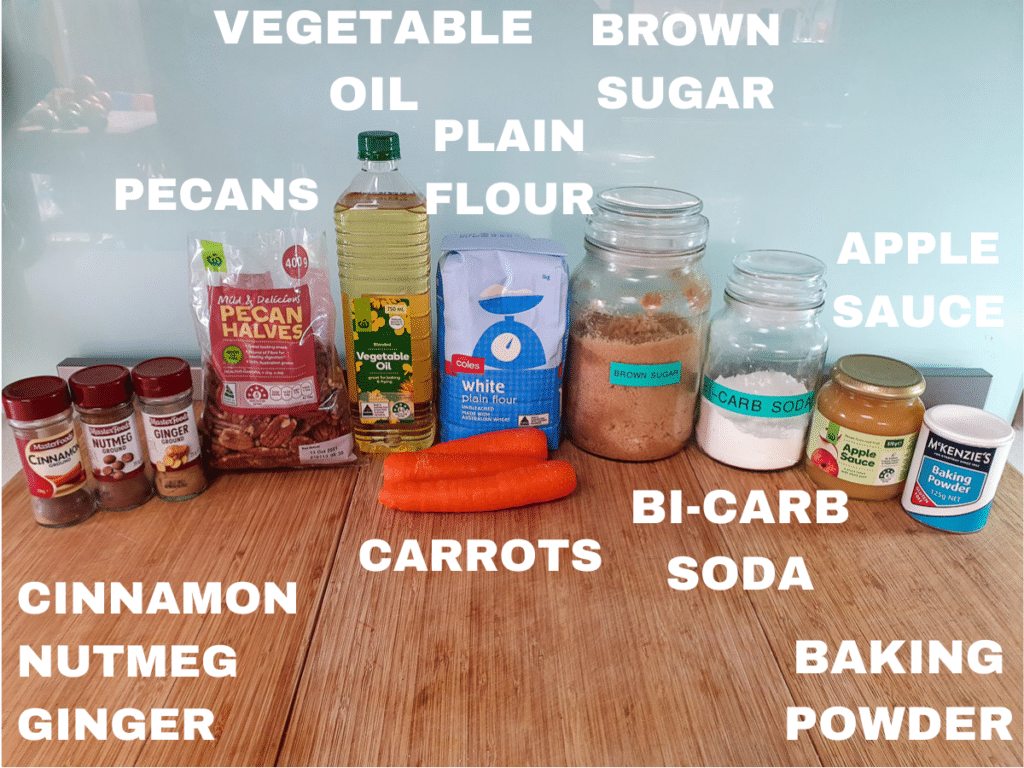 Eggless carrot cake ingredients, cinnamon, nutmeg, ginger, pecans, vegetable oil, carrots, plain flour, brown sugar, bi-carb soda, apple sauce, baking powder.