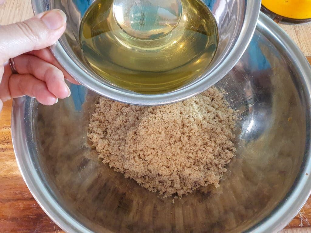 Adding oil to brown sugar.