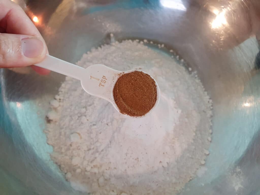 Adding cinnamon to flour.