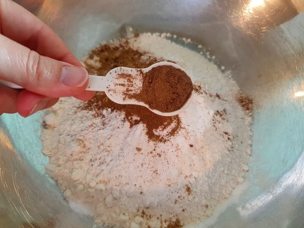 Adding nutmeg to flour.