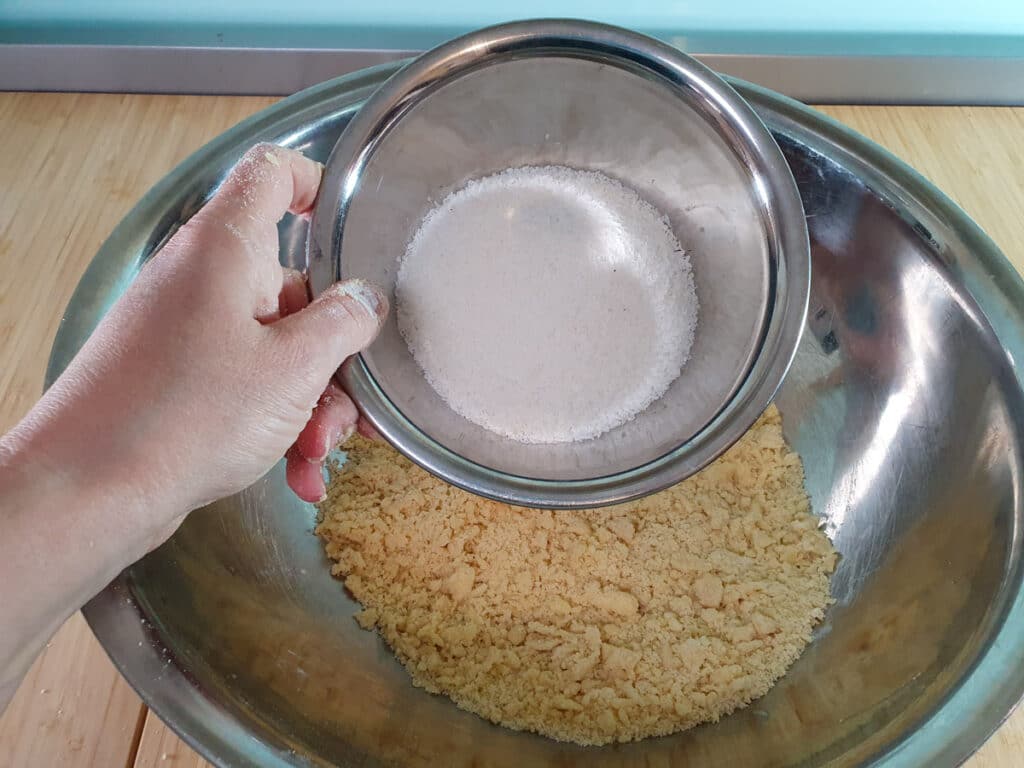 Feijoa crumble 7 Adding desiccated coconut to flour mix.