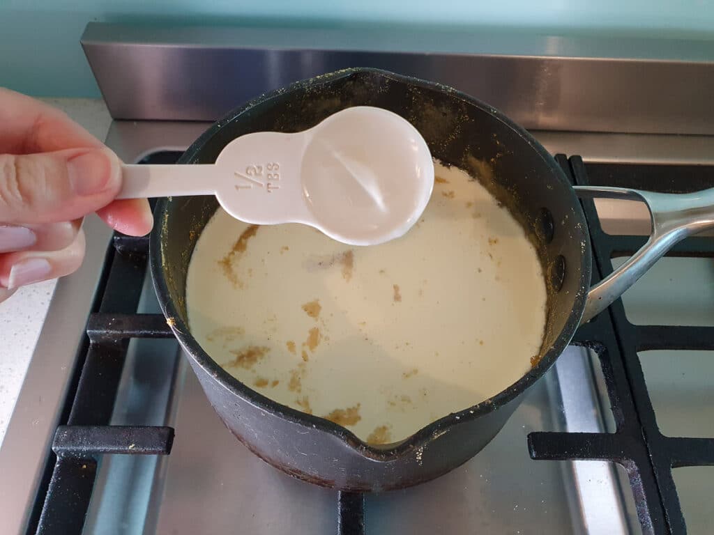 Adding glucose syrup to ice cream mix.