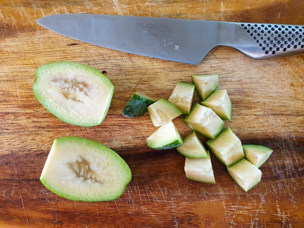 Chopping up whole feijoa with skin on.