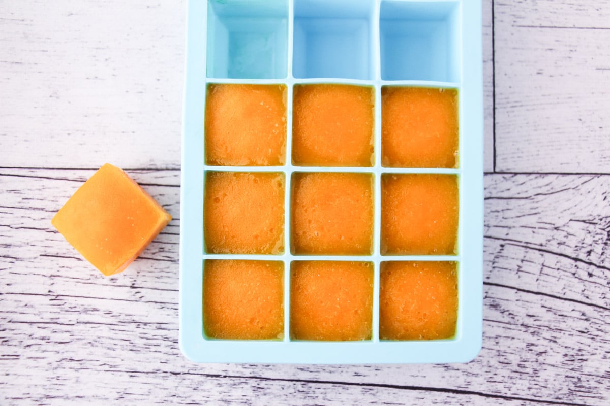 Mango coulis frozen in individual serves in ice cube molds.